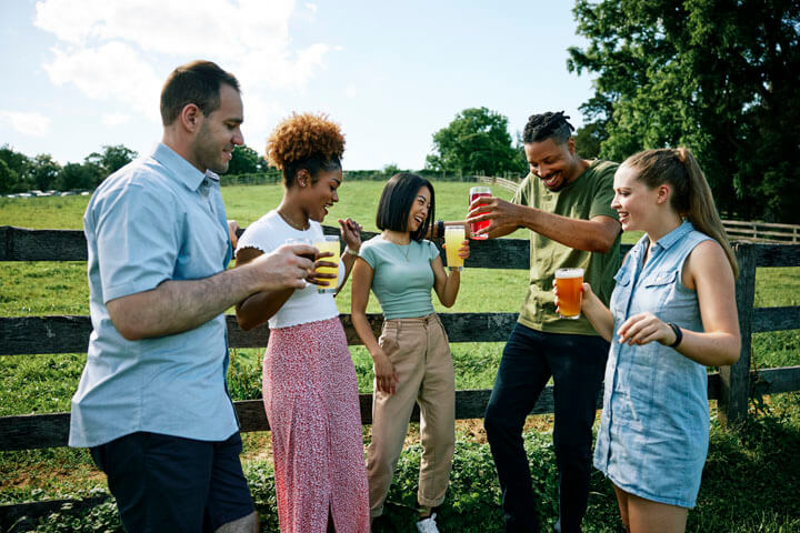 Friends enjoying drinks outdoors at Farmacy Brewing at Willowdale Farm in Reisterstown
