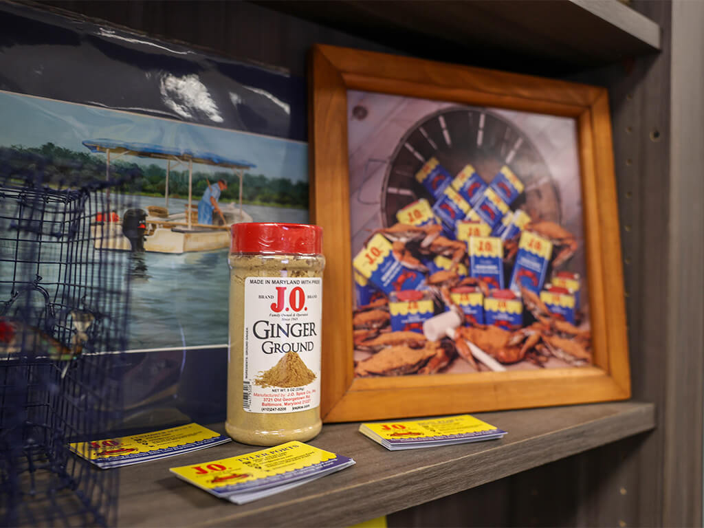 Story of J.O. Spice Company Inc. featuring a J.O. ground ginger spice bottle displayed with company memorabilia