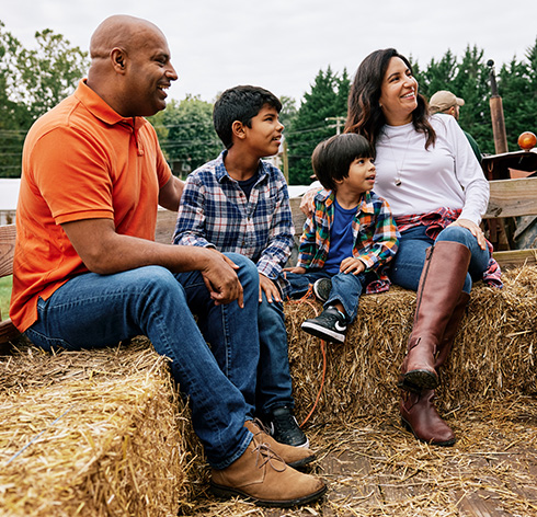 A family of four on a hayride in Baltimore County in the fall.