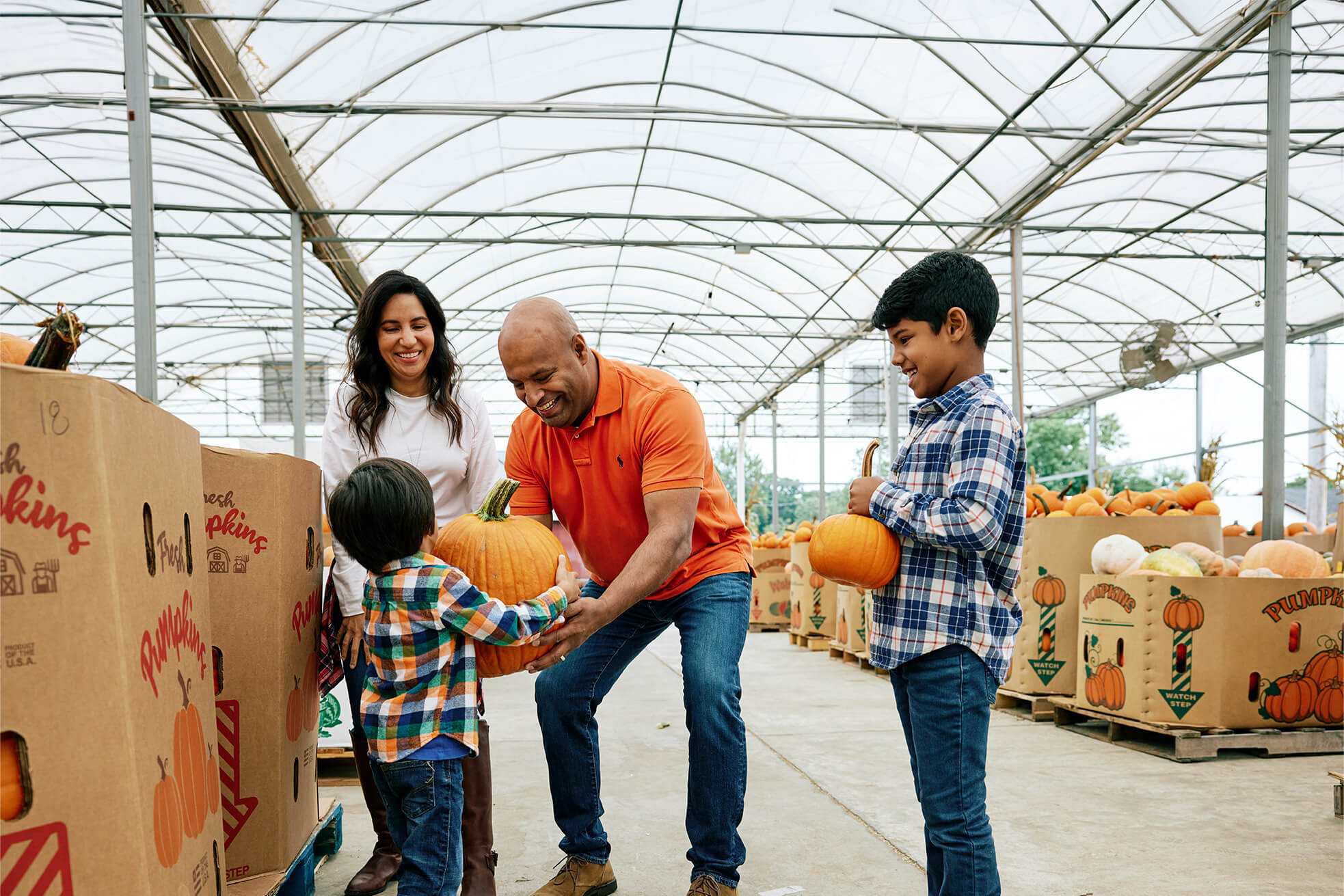 Family choosing pumpkins at a Baltimore County farm during a fall weekend getaway